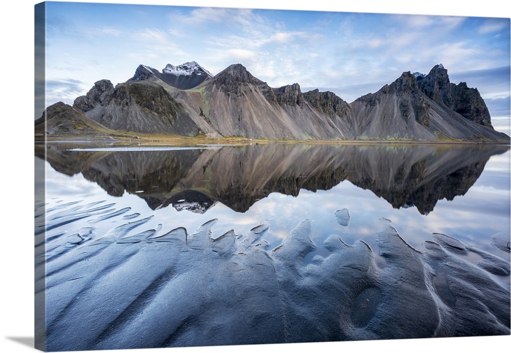 The mountains reflect on the surface of the ocean. Stokksnes, Eastern Iceland, Europe.