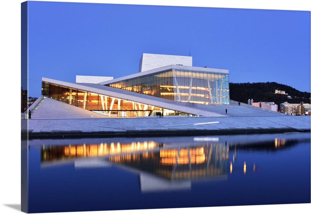 The Opera House, Norwegian National Opera and Ballet, by Snohetta architects in Bjorvika district, in the evening. Oslo, N...