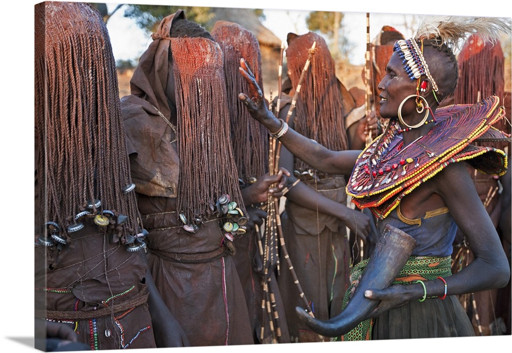 At the start of a Ngetunogh ceremony, the mothers of Pokot initiates will smear animal fat on the boys masks as a blessing...