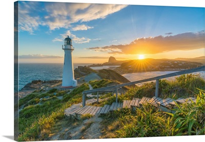 The Sun Is Setting Down Behind Castle Rock And Castlepoint Lighthouse, New Zealand