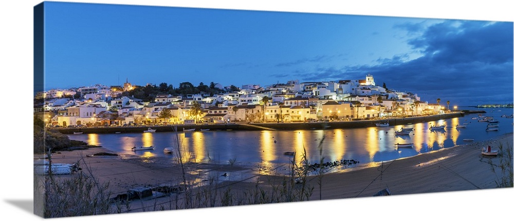 The traditional fishing village of Ferragudo at dusk. Algarve, Portugal.