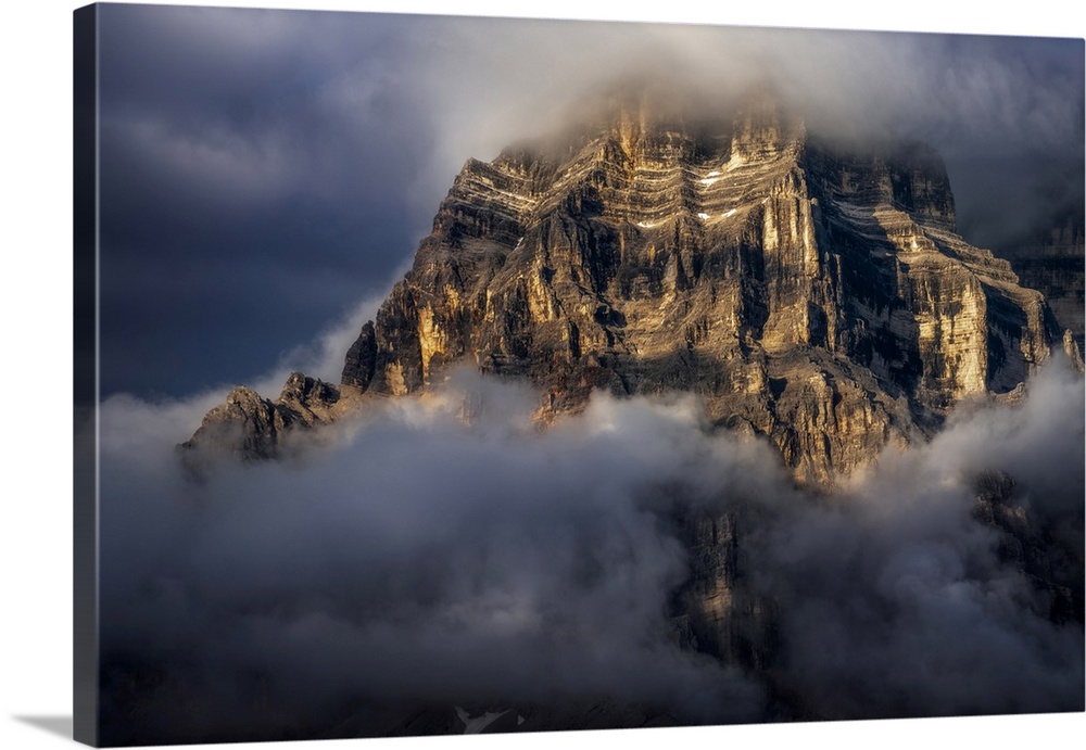 The walls of Mt. Pelmo in the Italian Dolomites hit by the golden light during a clearing storm in summer.