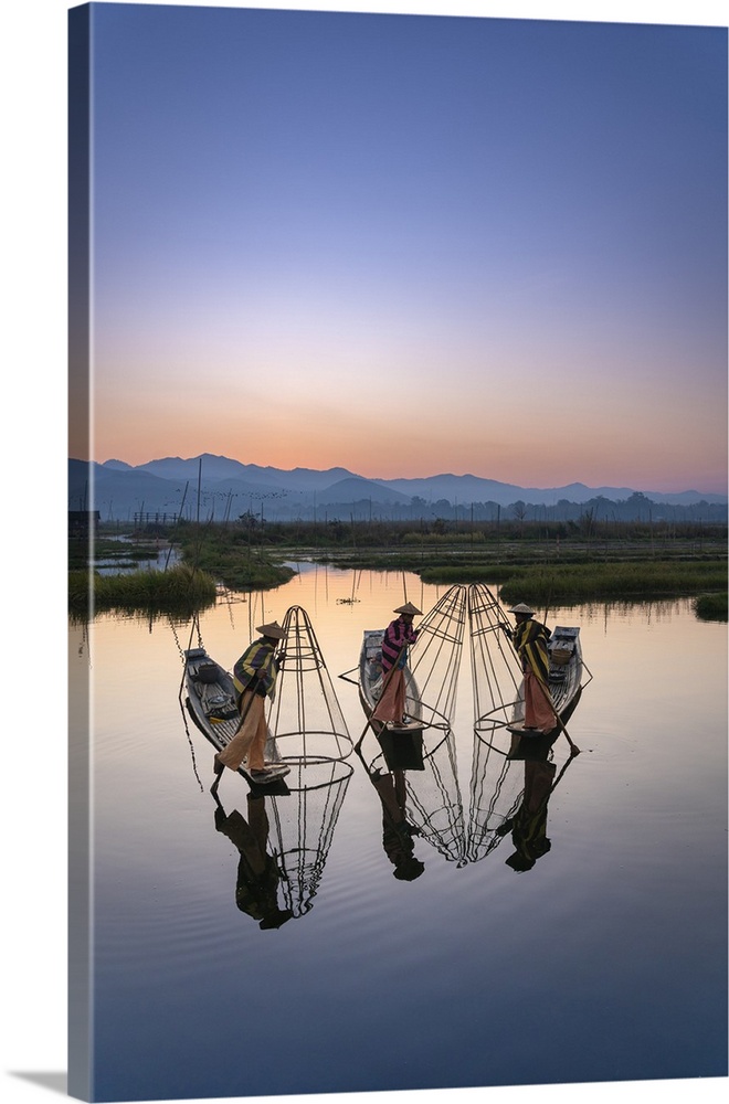 Three fishermen holding typical conical nets on their boats before sunrise, Floating Gardens, Lake Inle, Nyaungshwe Townsh...