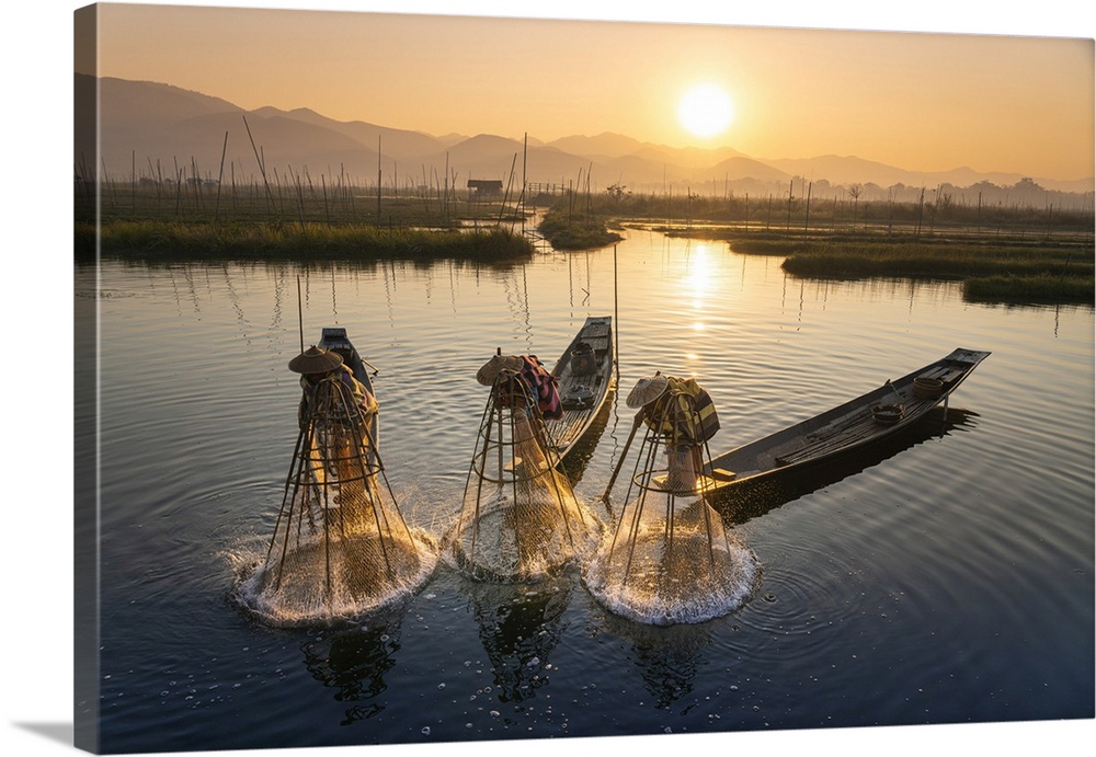 Three fishermen catching fish from boats using traditional conical nets at sunrise, Floating Gardens, Lake Inle, Nyaungshw...
