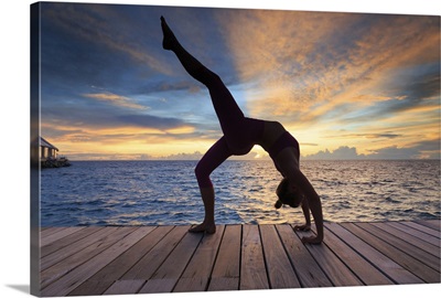 Thudufushi Island, Diamonds Thudufushi Resort, woman practising Yoga at sunset