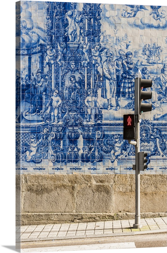 Traditional azulejos hand-painted tiles covering the exterior wall of the Capela das Almas church in Porto, Portugal.