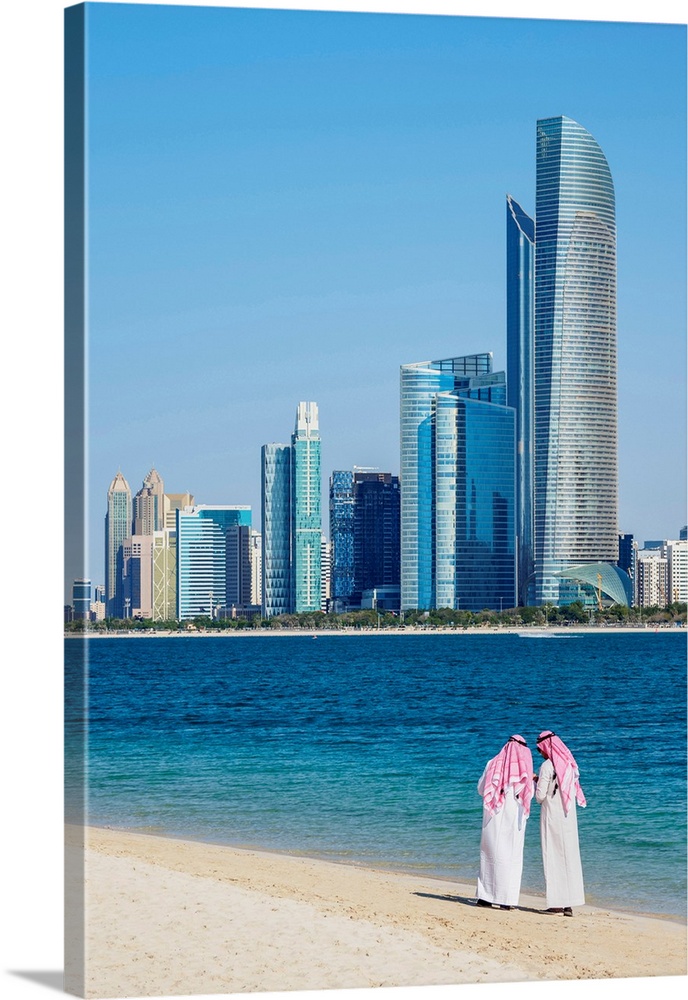 Two Men Wearing Thawb On The Beach And City Center Skyline, Abu Dhabi, United Arab Emirates
