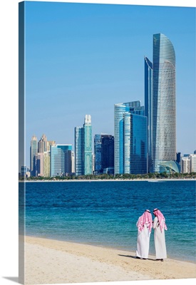 Two Men On The Beach And City Center Skyline, Abu Dhabi, United Arab Emirates