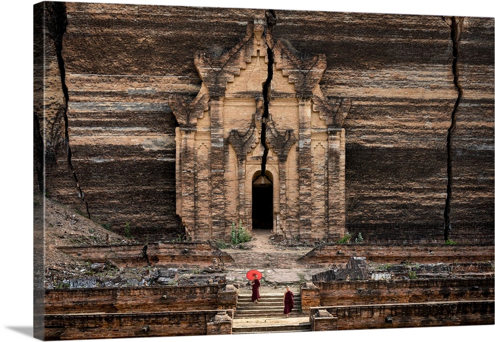 Two novice monks walking towards unfinished Pahtodawgyi pagoda known for a crack caused by a earthquake in 1839, Mingun, M...