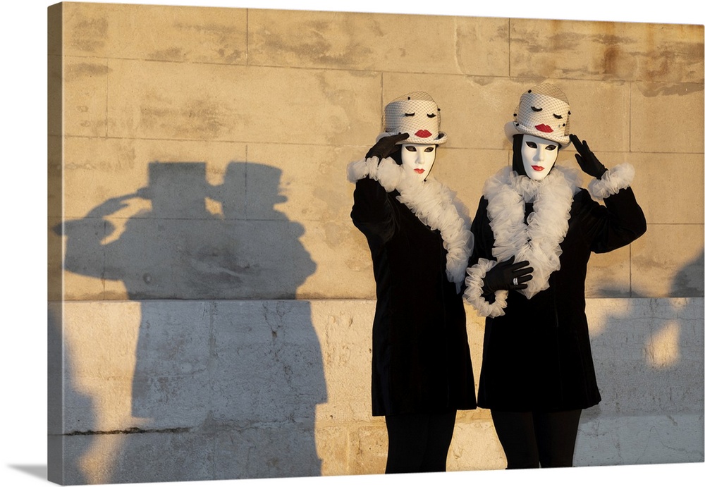 Two women pose in identical costumes during the Venice Carnival, San Giorgio Maggiore, Venice, Veneto, Italy