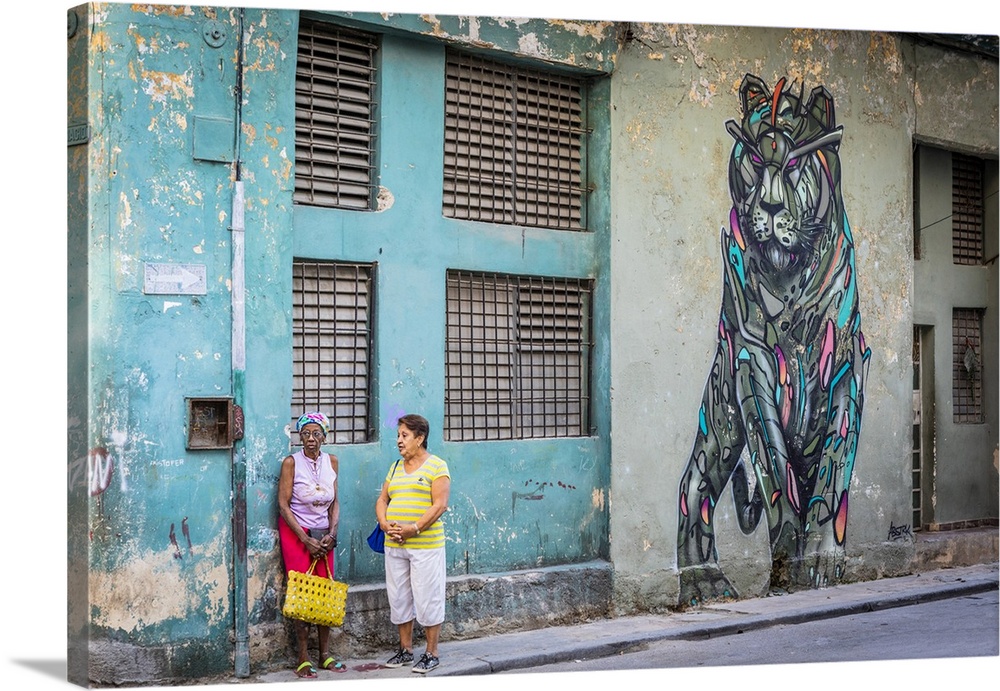 Two women talking in a street in La Habana Vieja (Old Town), Havana, Cuba