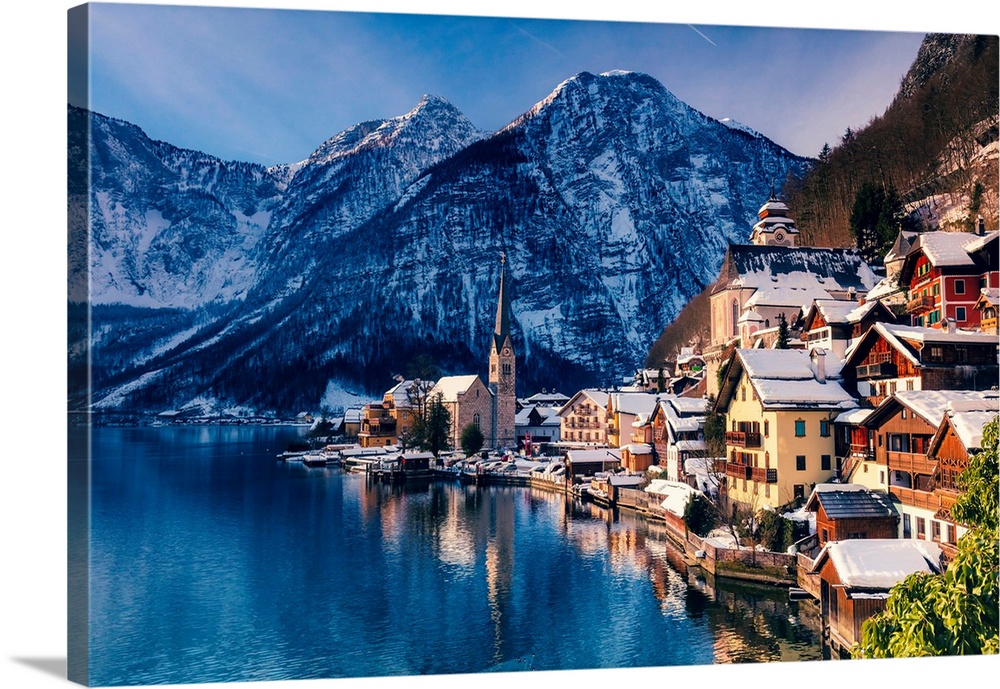 Typical village called Hallstatt con the Hallstatter see at sunrise with the houses reflecting in the lake.