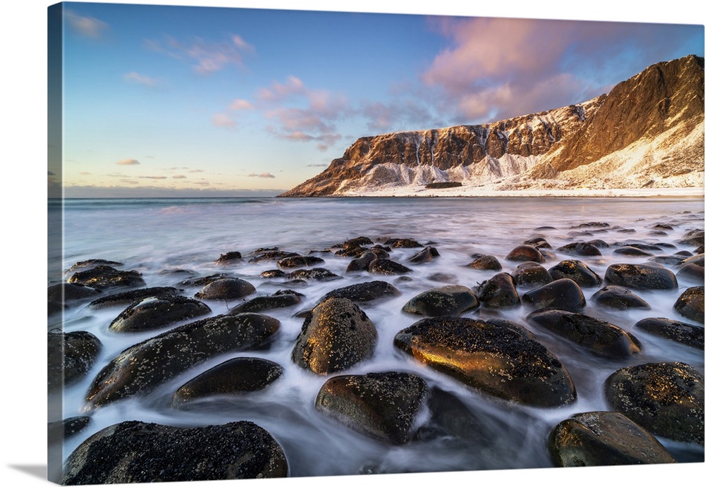 Unstad Beach with Kleivheia mountain in the background in winter at sunset. Vestvagoy municipality, Nordland county, North...