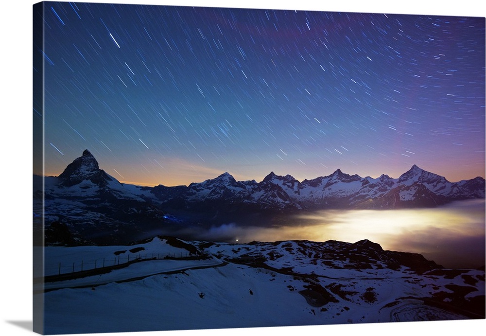 Europe, Valais, Swiss Alps, Switzerland, Zermatt, The Matterhorn (4478m) and town lights.