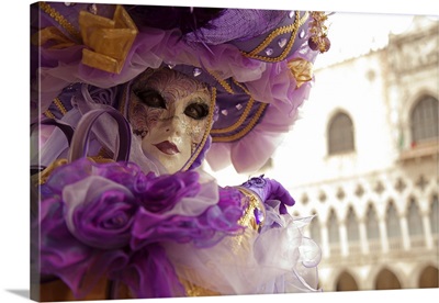 Venice, Italy, A masked character in front of the 'Palazzo dei Dogi' during Carnival