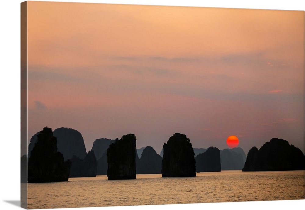 Vietnam, Quang Ninh Province, Ha Long Bay. Sunset among the two thousand limestone Karst islands in Ha Long Bay - a specta...