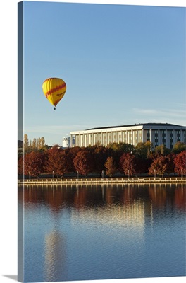 View across Lake Burley Griffin to hot air balloon and National Library of Australia