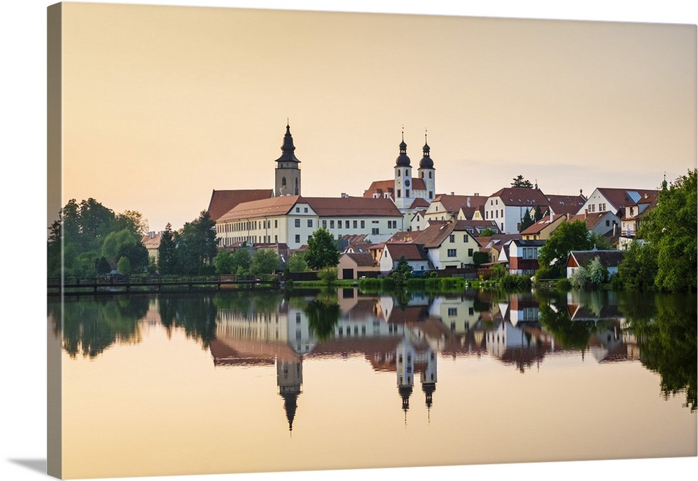 Czech Republic, Vysocina Region, Telc. View of town and Church of The Name of Jesus (Kostel jmena Jezis) at sunset.