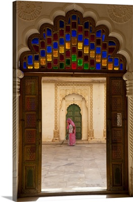 View through doorway of woman sweeping, Meherangarh Fort, Jodhpur, India