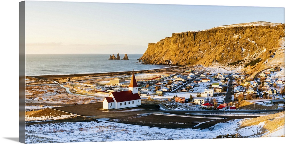 Vik i Myrdal, Southern Iceland, Iceland. Panoramic high angle view over Vik's church, the village, and the Reynisdrangar r...