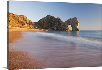 Waves sweeping onto the deserted beach at Durdle Door, Dorset, England