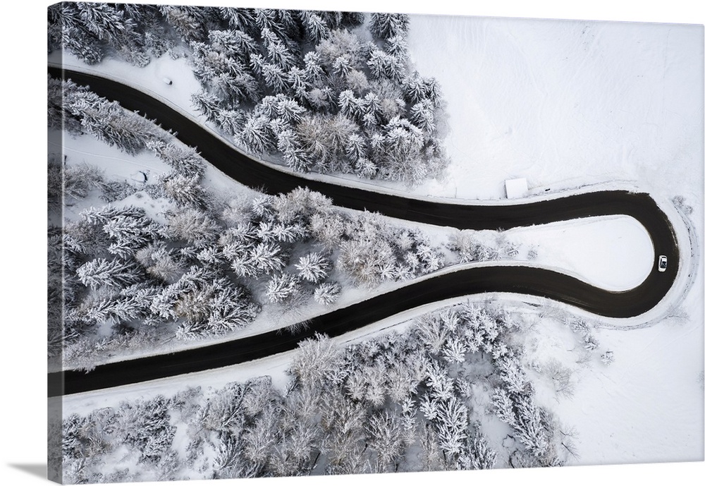 Aerial view of the winding road of the Presolana Pass after a winter snowfall. Presolana pass, Colere, Seriana Valley, Ber...