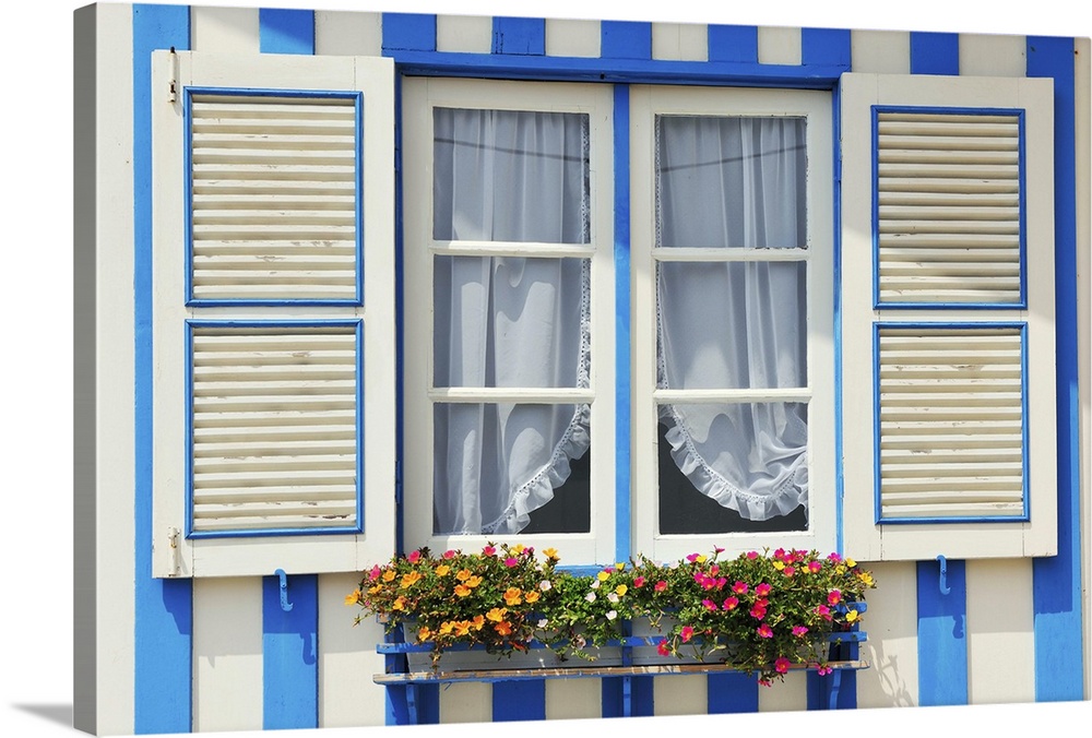 Window of a traditional striped painted house in the little seaside village of Costa Nova, Portugal