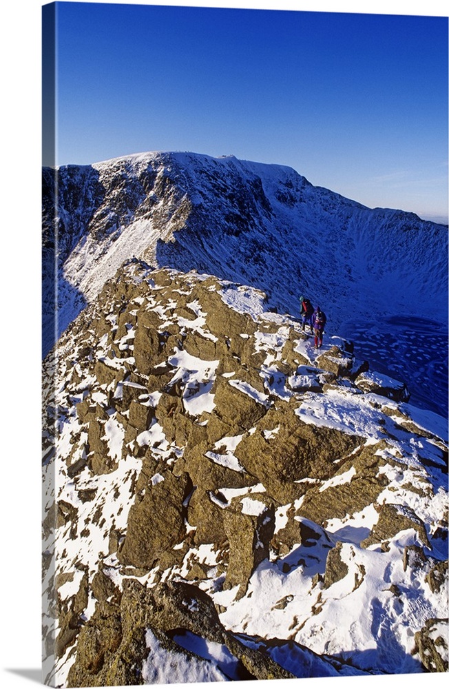 Winter walking and climbing on Hellvelyn, The Lake District, Cumbria.