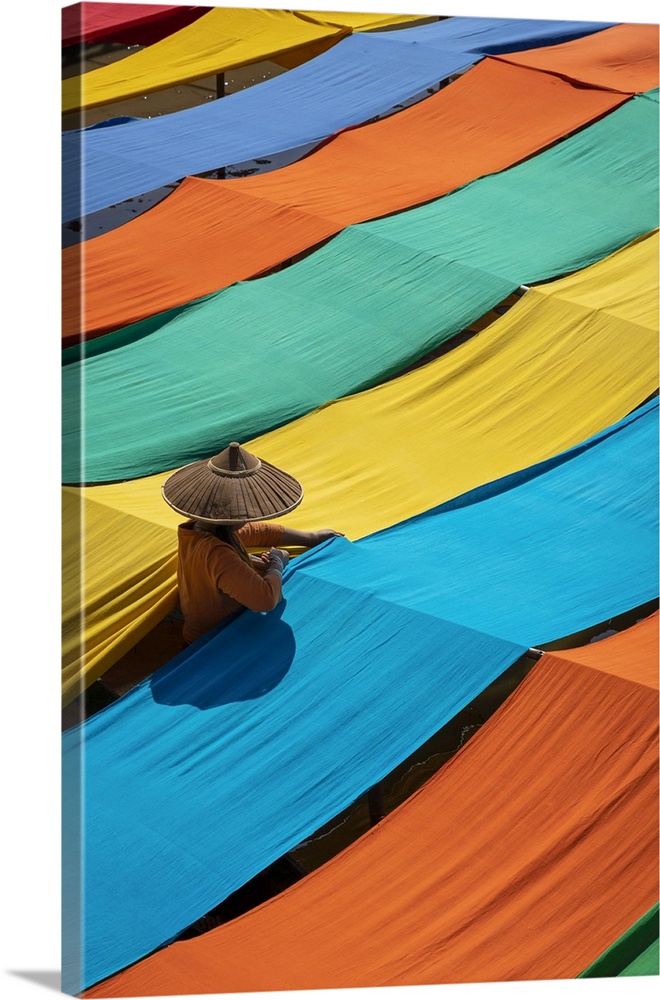 Elevated view of woman hanging long pieces of dyed fabric to dry, Lake Inle, Nyaungshwe Township, Taunggyi District, Shan ...