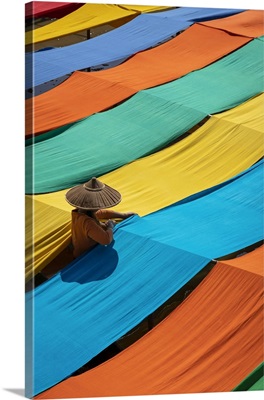 Woman Hanging Long Pieces Of Dyed Fabric To Dry, Lake Inle, Myanmar