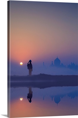 Woman On A Foggy Morning With The Sun Rising On The Taj Mahal, India