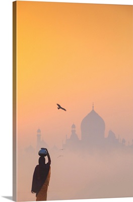 Woman On A Foggy Morning With The Sun Rising On The Taj Mahal, India