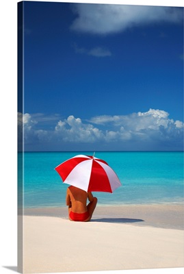 Woman Sitting On Beach With Red And White Umbrella, Barbuda, Caribbean, West Indies