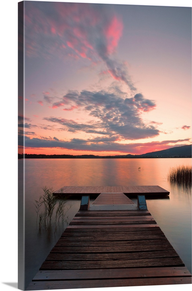 Wood pier on Pusiano lake at sunset, Bosisio Parini, Lecco province, Lombardy, Italy.