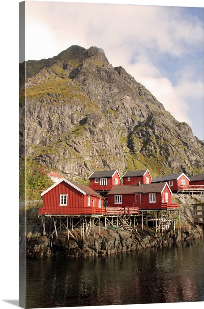 Wooden fishermen's cabins on stilts, known locally as rorbu and now mostly used as tourist accommodation, in a village on ...