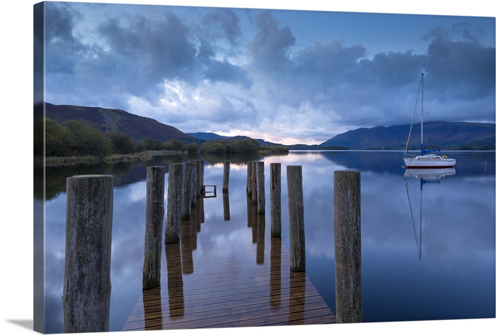 Wooden jetty and yacht on Derwent Water near Lodore, Lake District, Cumbria, England. Autumn (October)