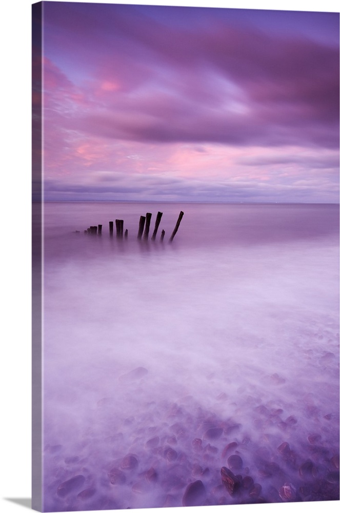 Wooden posts at high tide on Porlock Beach, Exmoor, Somerset.