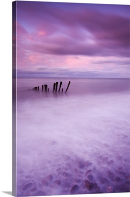 Wooden posts at high tide on Porlock Beach, Exmoor, Somerset