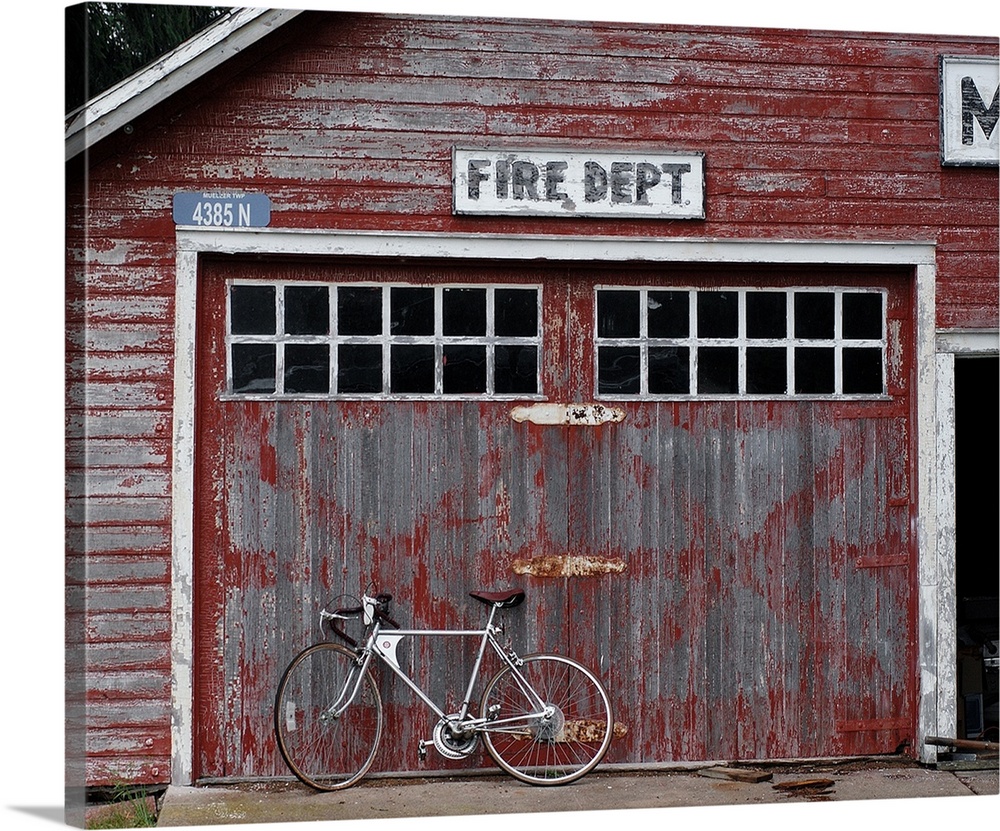Rustic fire dept. with a bicycle leaning against it in Michigan