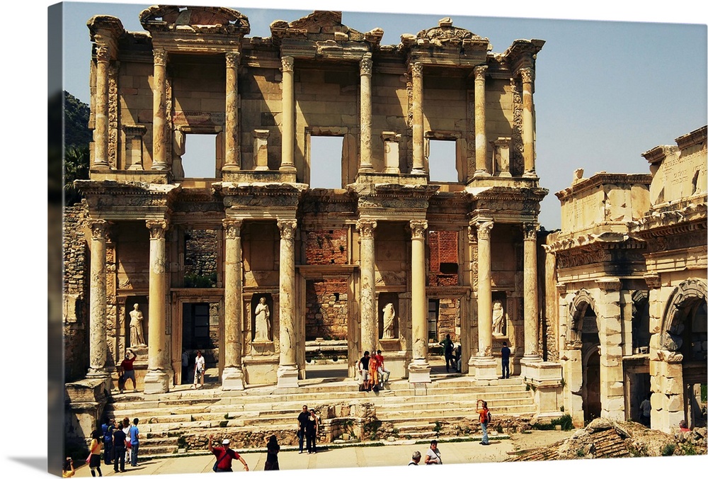 Tourists gather around the archaeological remains of the Library of Celsus; Ephesus, Turkey. Ephesus, located along the we...