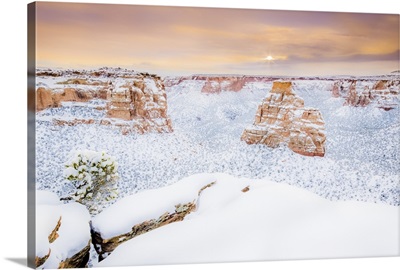 Sun rises over the landscape of fresh snow, Colorado National Monument