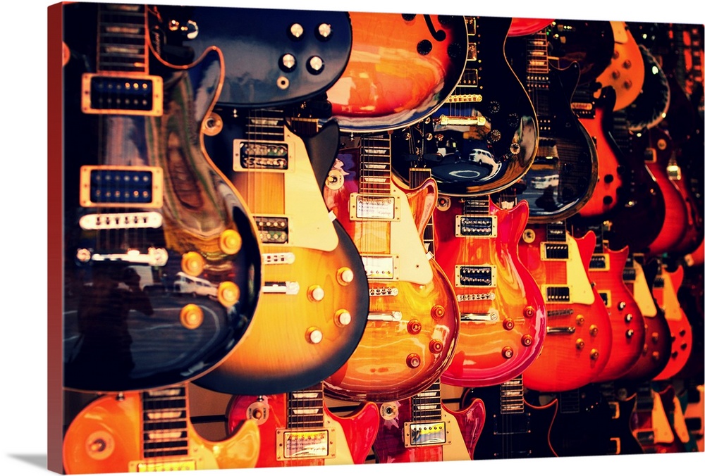 An image of electric guitars on a wall.