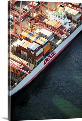 Crane loading cargo onto container ship, Port of Seattle, WA - Aerial Photograph