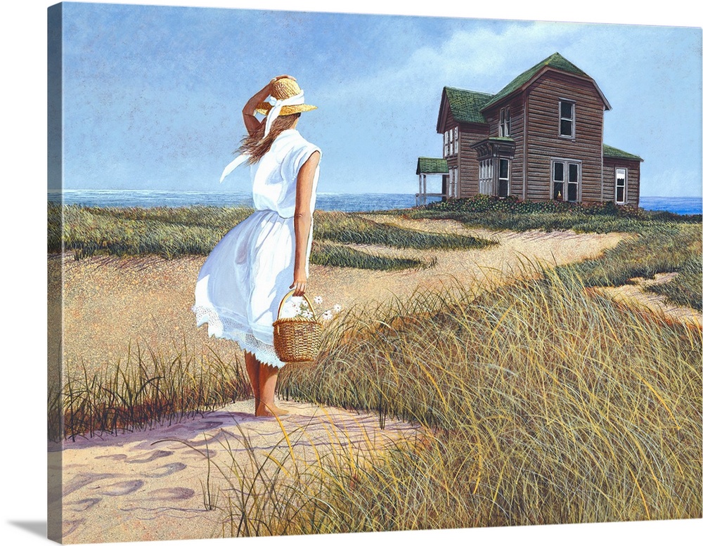 Woman in a white dress with a straw hat on holding a basket of flowers on sandy beach looking at a beach front house.