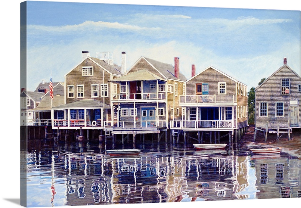 Houses on harbor wharf with dock and moored boats.