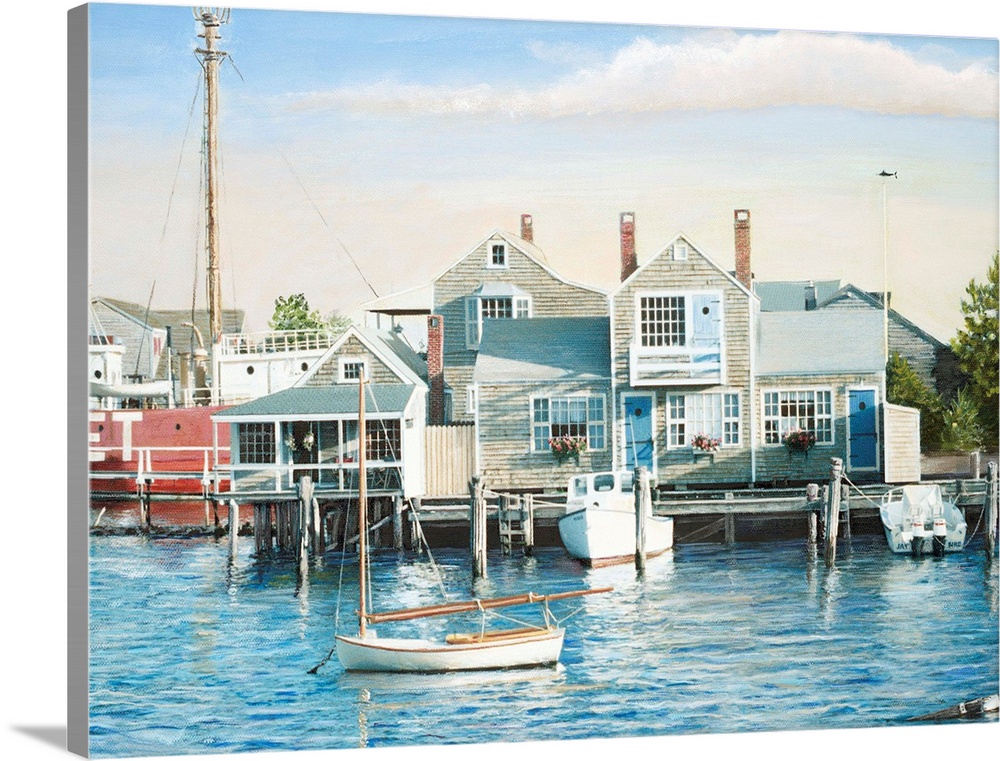 Houses on harbor wharf with dock and moored boats.