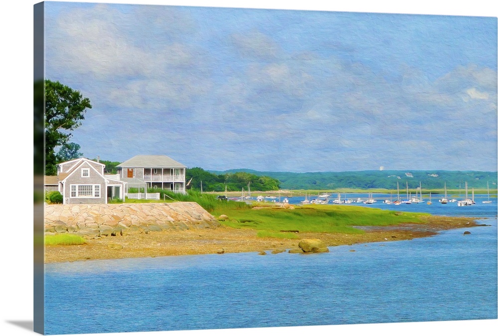 A house on the sea shore with sailboats in the distance in New England.