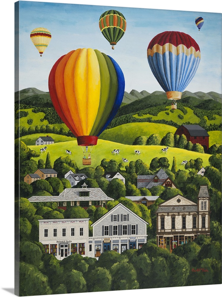 Colorful hot air balloons floating above a hillside town.