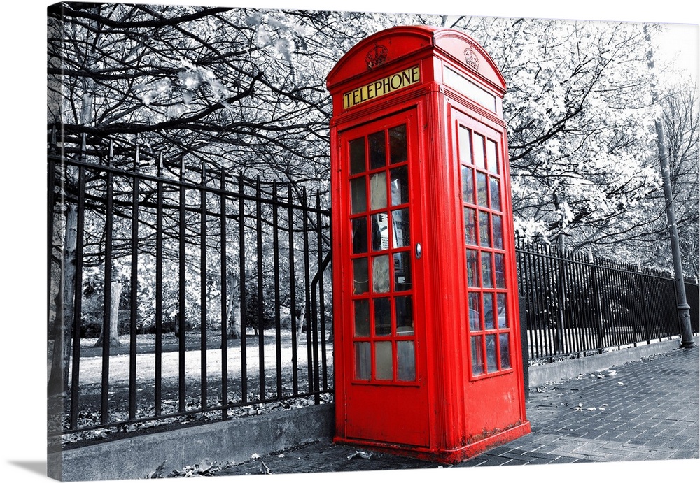 Large black and white photo on canvas with a phone booth kept in color.