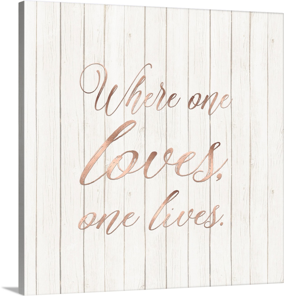 "Where One Loves, One Lives." written in rose gold on a wood paneled background.